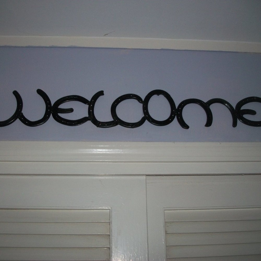"Welcome" sign made with horse shoes - man made